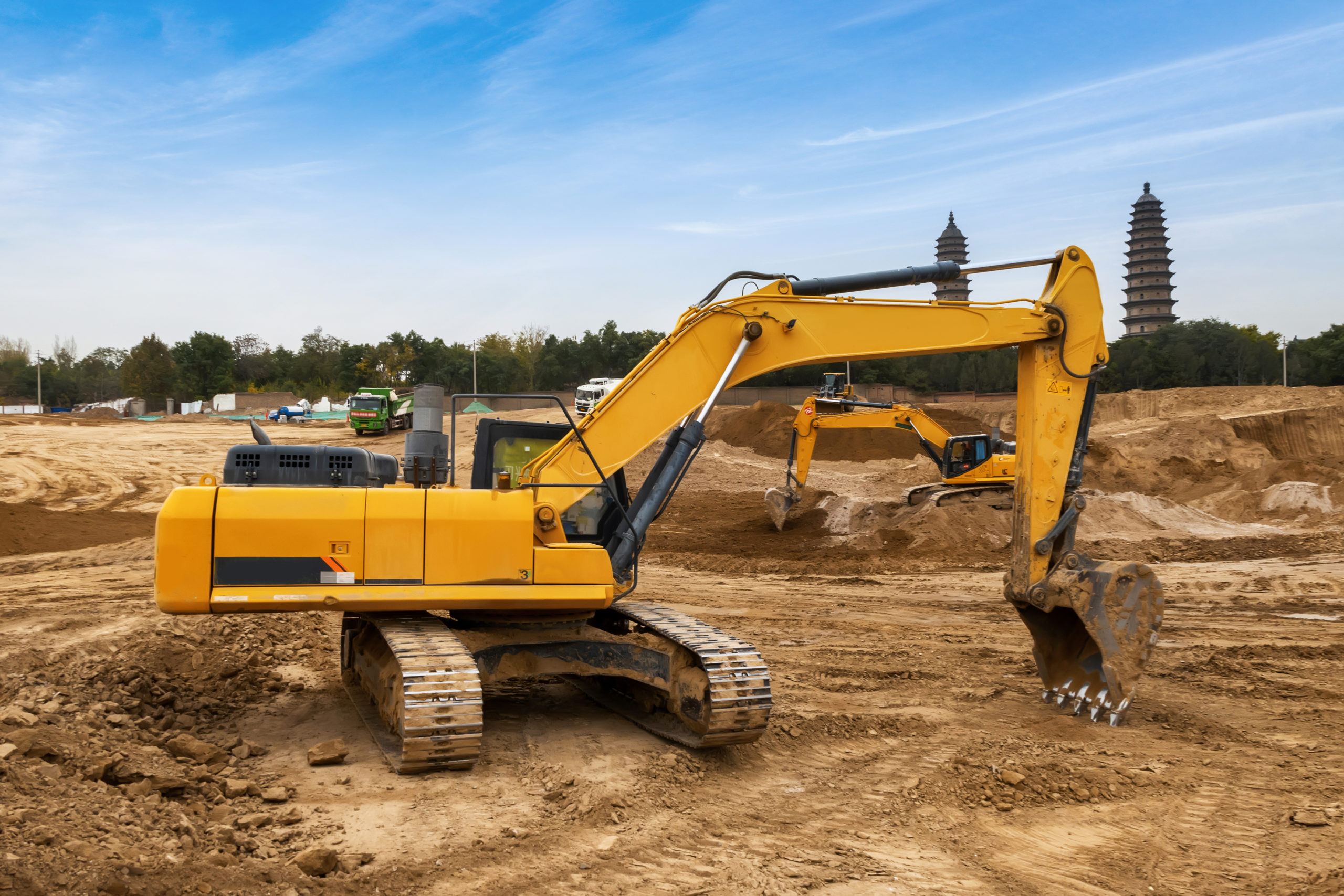 Excavators excavate earth at the construction site