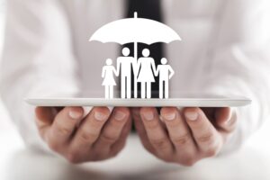 Businessman protects family members with an umbrella on a digital tablet